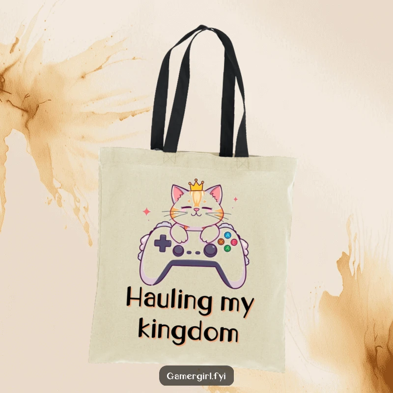 Funny tote bag portraying a crowned cat lounging on a huge, soft gaming controller. Ideal for carrying gamer accessories.